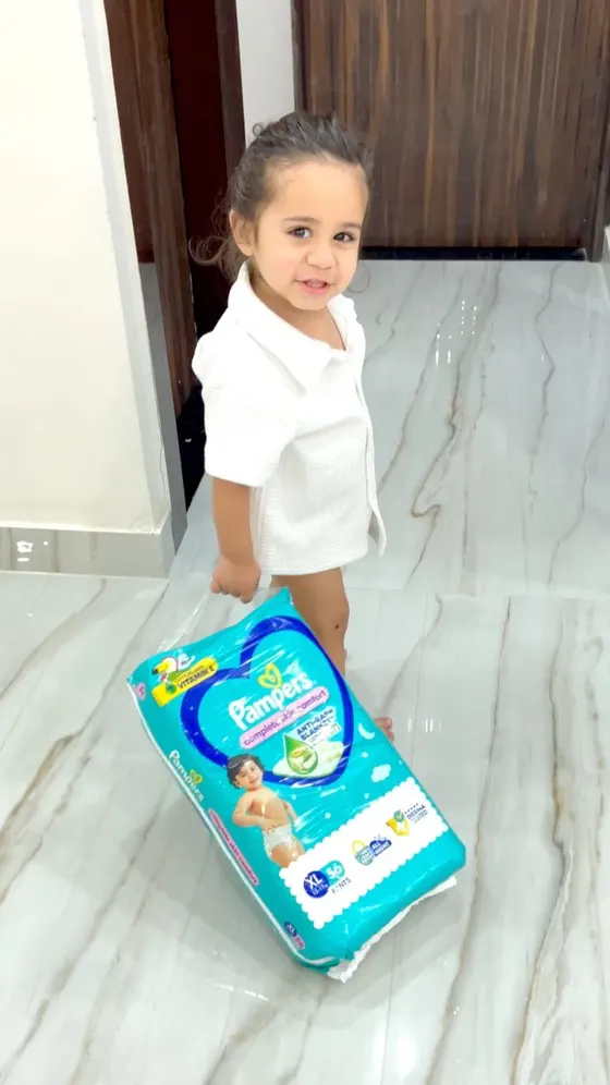 Pampers ad showing a toddler with a Pampers pack
